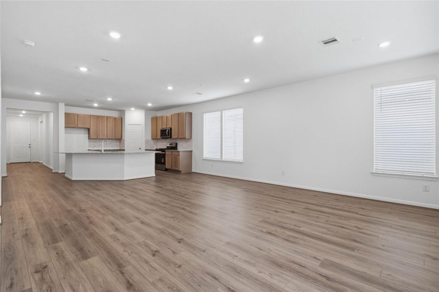 Stunning open-concept design seamlessly connecting the living, dining, and kitchen areas—perfect for both everyday living and entertaining!