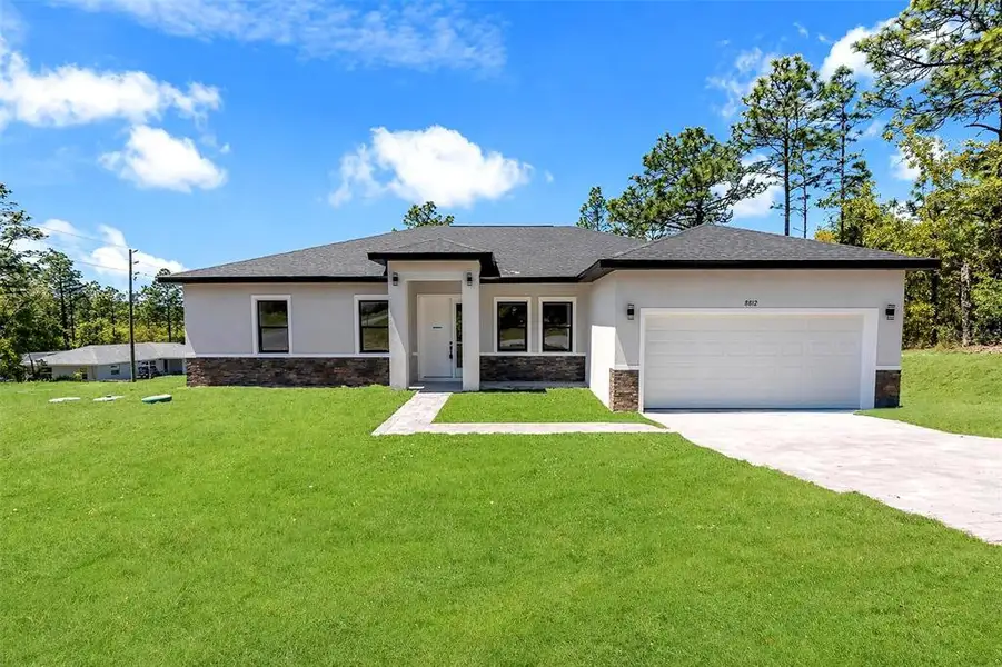 Front exterior of a new home in , Citrus Springs, FL, highlighting curb appeal (Image 23).
