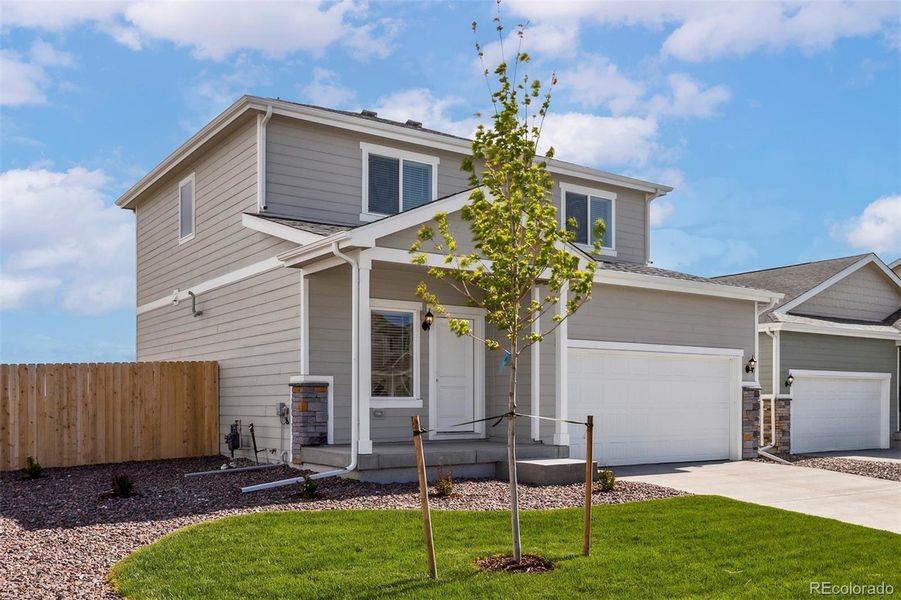 Front exterior of a new home in Bennett Ranch, Bennett, CO, highlighting curb appeal (Image 1). Front exterior of a new home in Bennett Ranch, Bennett, CO, highlighting curb appeal (Image 1).