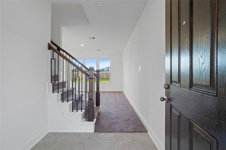 Welcome inside 25307 Ashbourne Court! As you come inside, you are greeted by the view of the beautiful staircase and natural light.