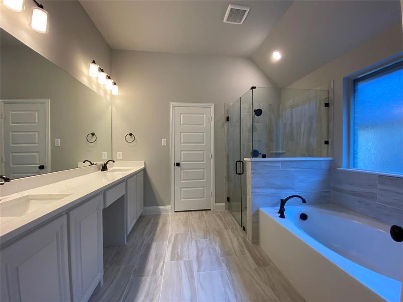 Same master bath colors & plan, but this hoem has a freestanding bath tub.