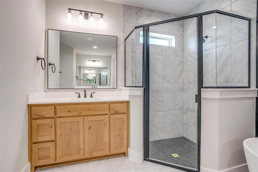 Bathroom featuring independent shower and bath, tile patterned floors, and vanity