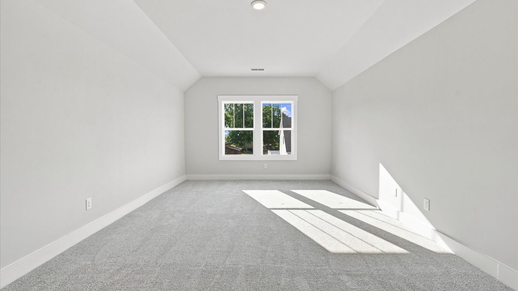 Top-notch design defines this bonus room with carpeted floors and an open, airy layout in Inman, SC