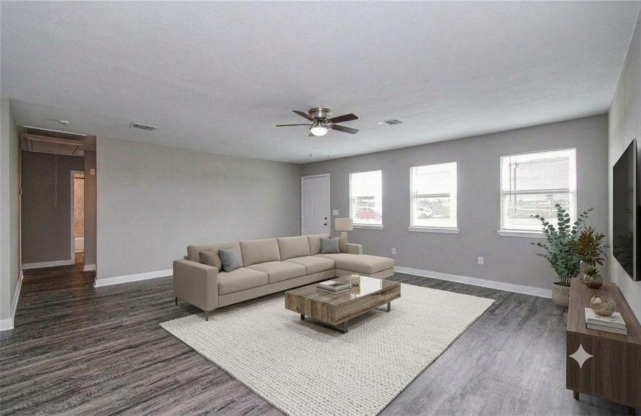Generously sized living space with durable wood-look flooring and abundant natural light. (Virtually Staged)