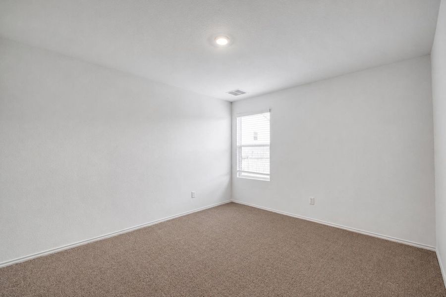 Carpeted room featuring a single window, recessed lighting, and white baseboards Carpeted room featuring a single window, recessed lighting, and white baseboards