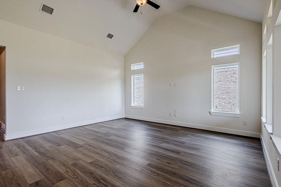 The spacious family room features soaring ceilings and an open layout designed for both relaxation and entertaining The spacious family room features soaring ceilings and an open layout designed for both relaxation and entertaining