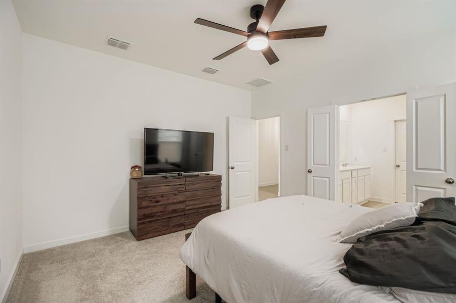 Bedroom featuring light colored carpet and a ceiling fan
