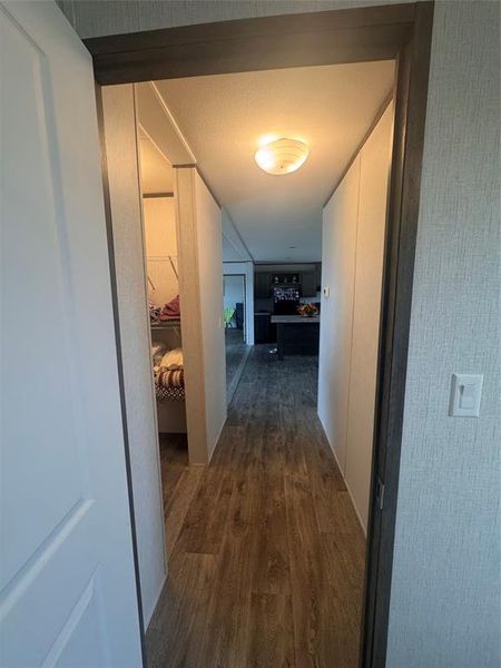 Hall featuring dark wood-style flooring Hall featuring dark wood-style flooring