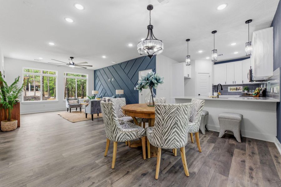 An open-concept living space with sleek flooring and ample natural light invites comfortable gatherings.