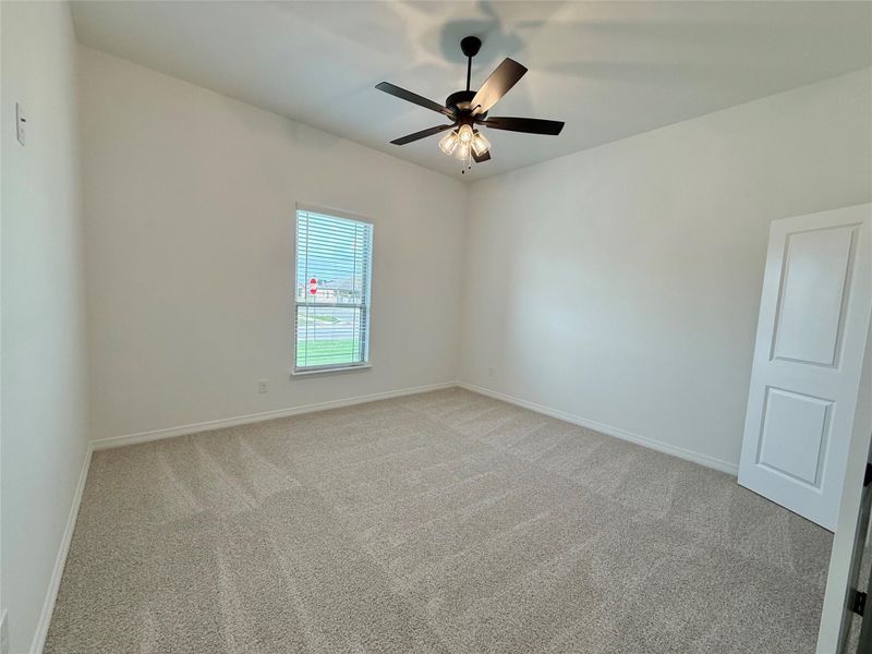 Carpeted room with vaulted ceilings and a ceiling fan with integrated lighting