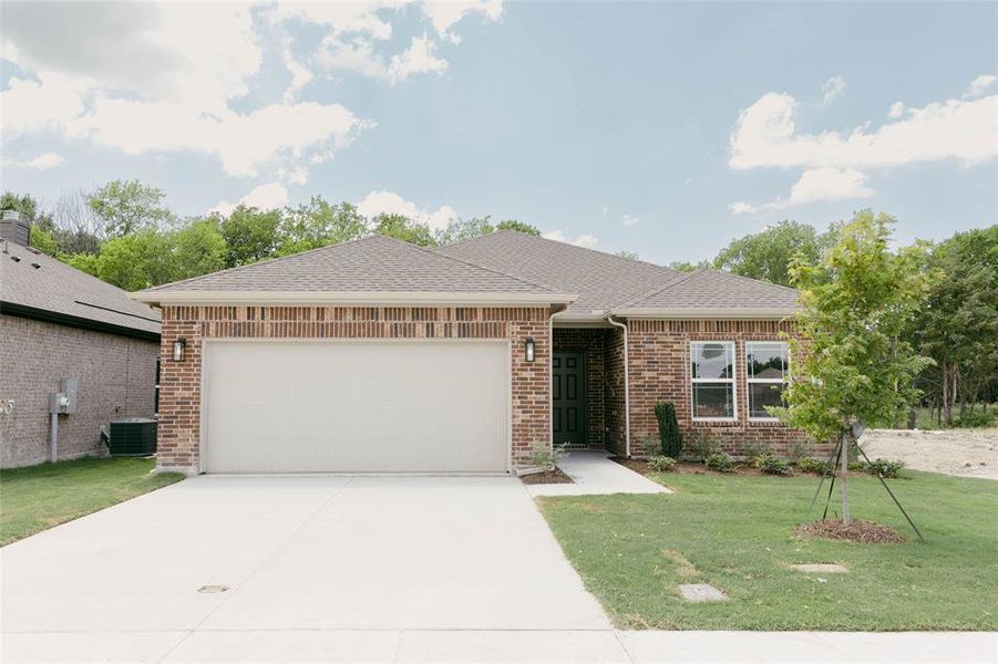 View of front of property with a garage, central AC, and a front yard