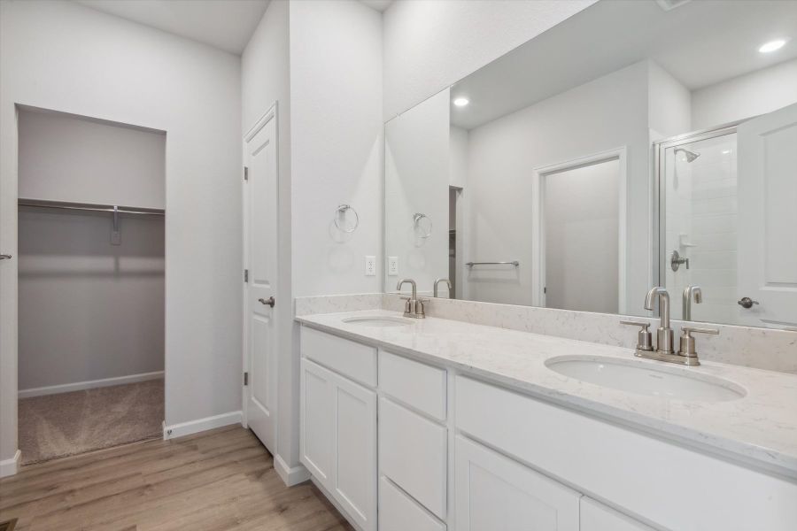 A bathroom with a large mirror.