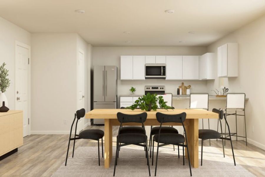 A kitchen with a table and chairs.