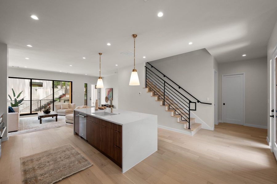 An open-concept living space with sleek flooring and a contemporary staircase welcomes you. An open-concept living space with sleek flooring and a contemporary staircase welcomes you.