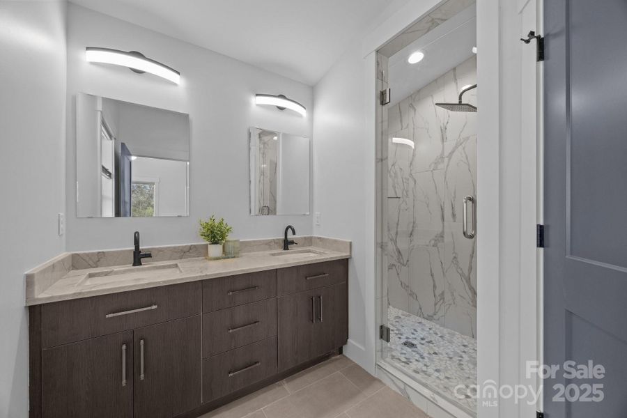 Primary bath features a walk in shower with rain head fixture