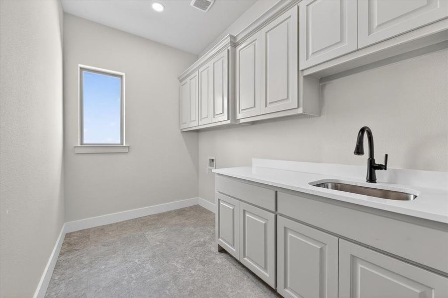 Laundry room with cabinet space, hookup for a washing machine, and recessed lighting