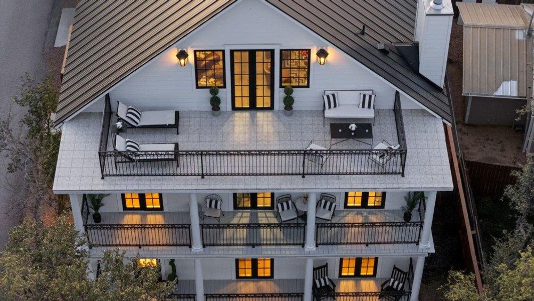 Rear view of house with a balcony and a chimney