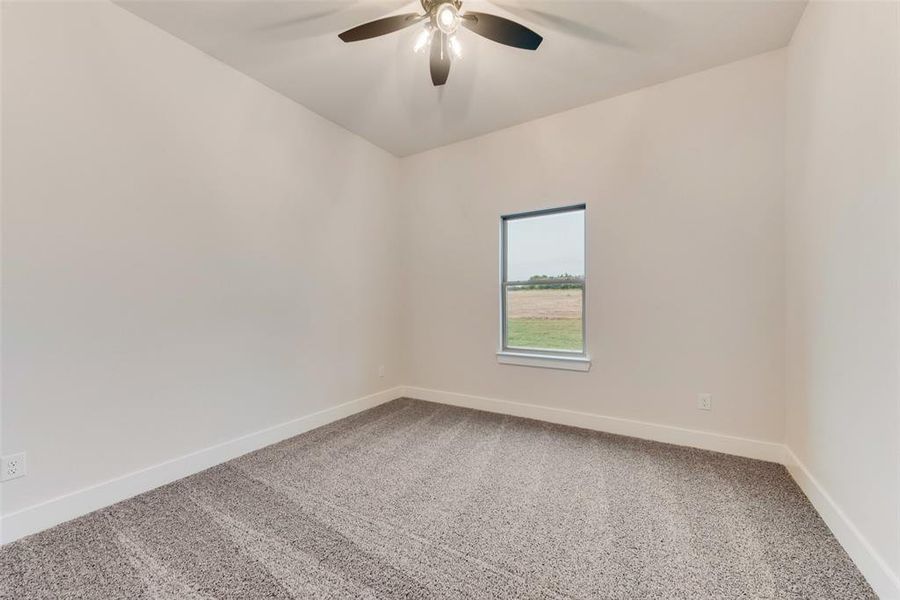 Spare room featuring carpet flooring and ceiling fan Spare room featuring carpet flooring and ceiling fan