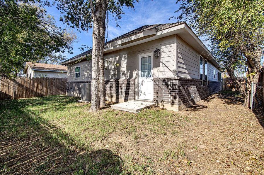 Rear view of house featuring a lawn