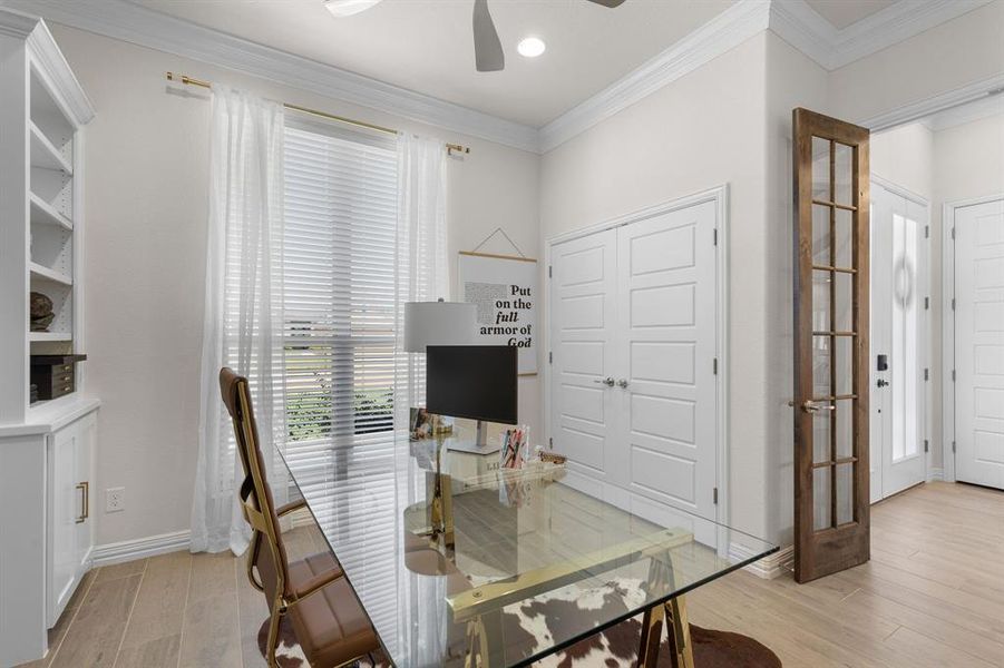 Office space featuring crown molding, light wood-style floors, french doors, and ceiling fan Office space featuring crown molding, light wood-style floors, french doors, and ceiling fan