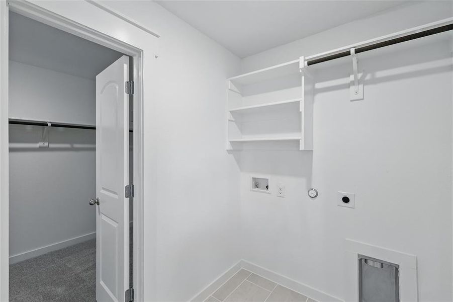 Clothes washing area with laundry area, hookup for a washing machine, hookup for an electric dryer, gas dryer hookup, and baseboards Clothes washing area with laundry area, hookup for a washing machine, hookup for an electric dryer, gas dryer hookup, and baseboards