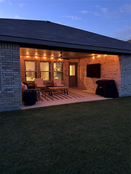 Covered back patio with TV that conveys!