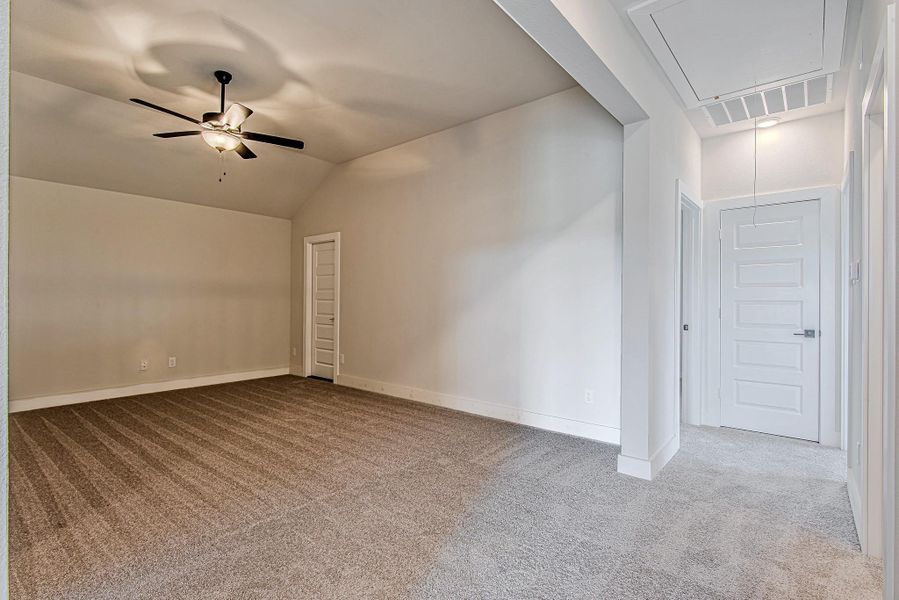 Another angle of the game room/bonus area highlights the open-concept flow and sightlines to the hallway and stair landing.