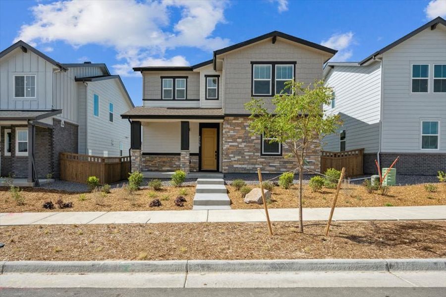 A house with a tree in the front.