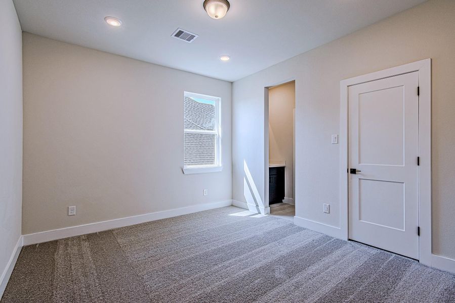 Spacious secondary bedroom with a large window and private closet