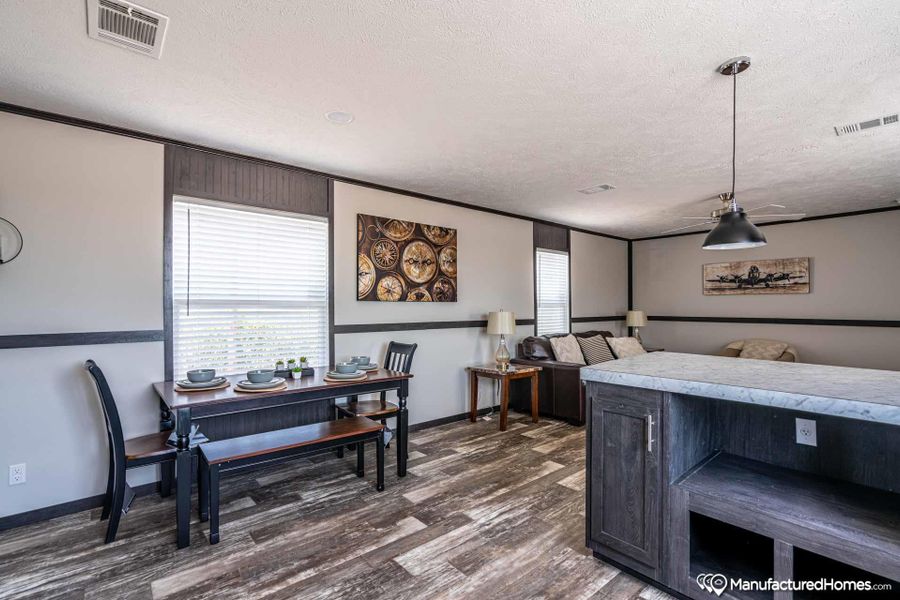 An inviting open-concept living and dining area boasts stylish laminate flooring and ample natural light.