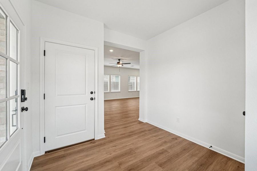 A welcoming entryway with durable wood-look flooring leads to an open-concept living space. A welcoming entryway with durable wood-look flooring leads to an open-concept living space.