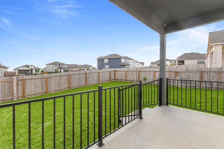 A fenced backyard with a lush green lawn offers private outdoor enjoyment. A fenced backyard with a lush green lawn offers private outdoor enjoyment.
