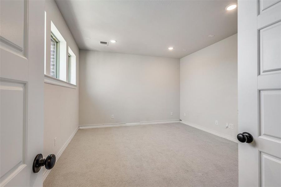 Spare room with light carpet and recessed lighting