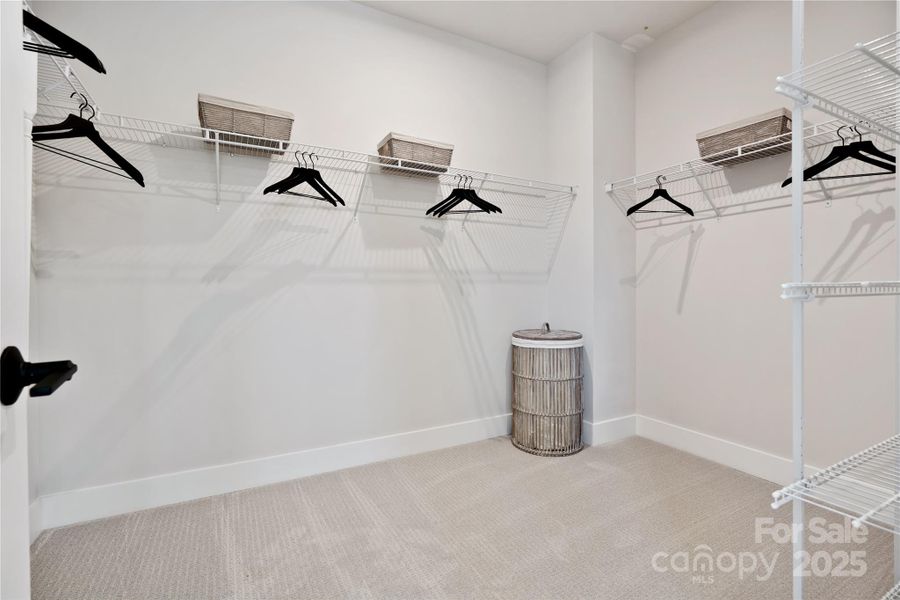 Expansive walk-in closet at primary suite. *Model Photos | actual finishes, structural selections, and orientation may vary.