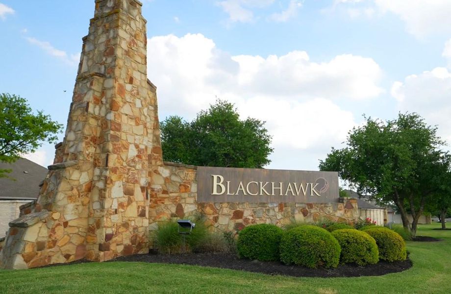 Community / neighborhood sign featuring a lawn