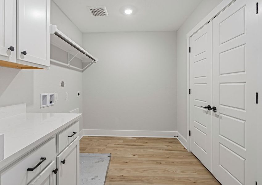 The laundry room is upstairs and has hanging space and cabinet space. The laundry room is upstairs and has hanging space and cabinet space.