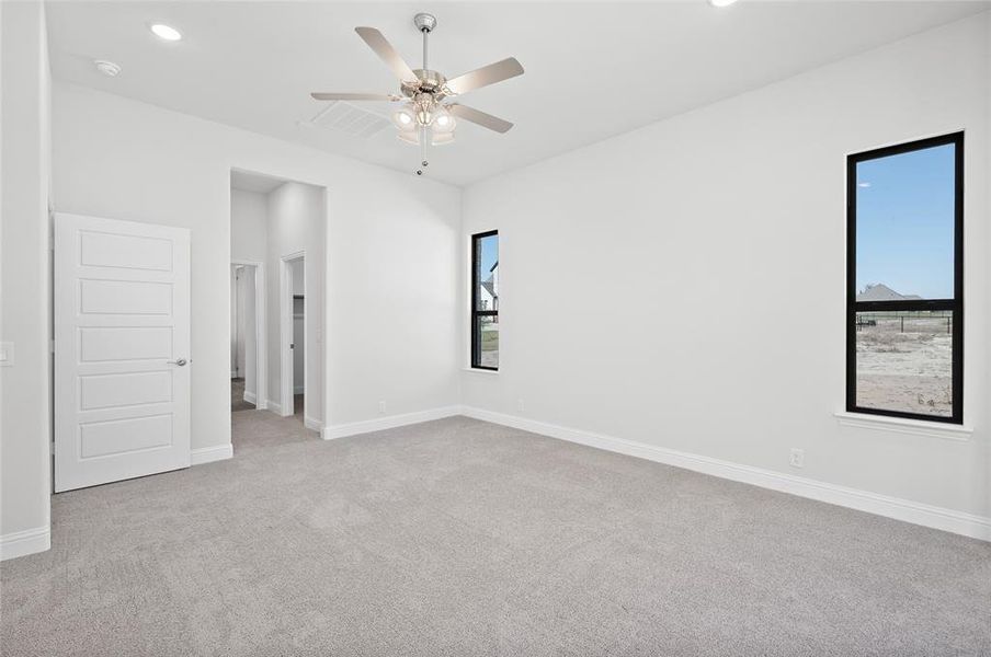 Unfurnished bedroom with light colored carpet, recessed lighting, and a ceiling fan Unfurnished bedroom with light colored carpet, recessed lighting, and a ceiling fan