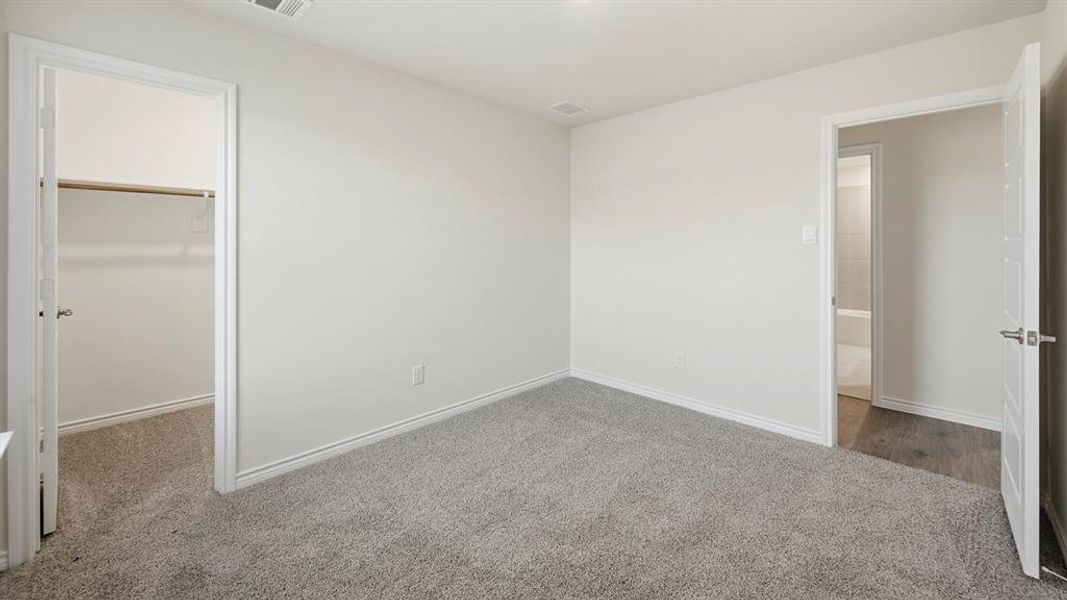 The room features neutral-toned walls, grey carpeting, and white trim