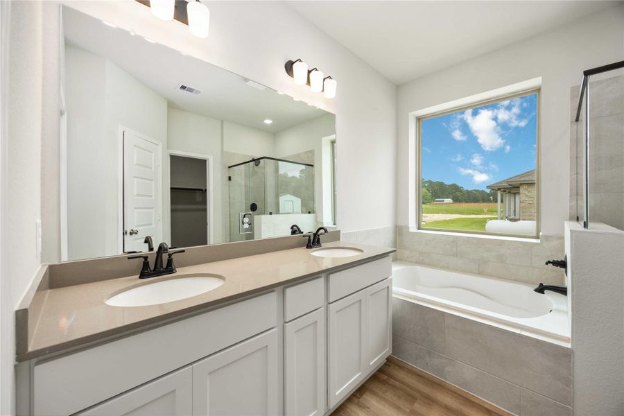 The ensuite bathroom is complete with the upgraded double vanity sink and modern black hardware. The ensuite bathroom is complete with the upgraded double vanity sink and modern black hardware.