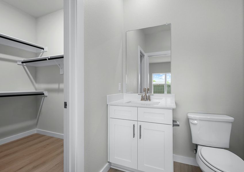 The master bathroom has a white vanity and connects to the closet