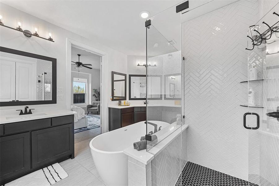 Full bathroom with a sink, tile patterned flooring, a freestanding tub, two vanities, and a shower stall