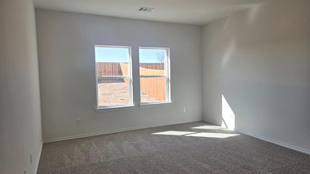 Carpeted spare room with baseboards