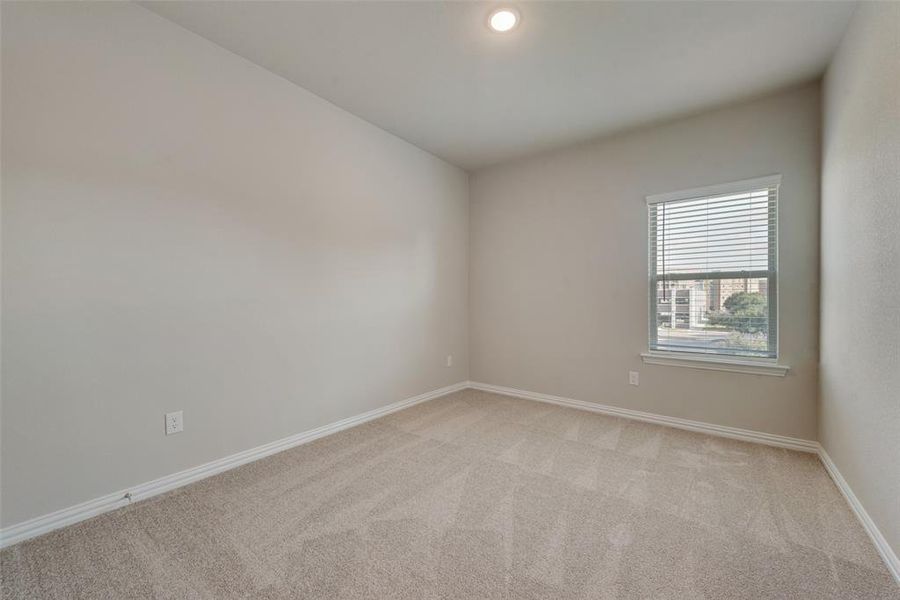 Spare room featuring light colored carpet