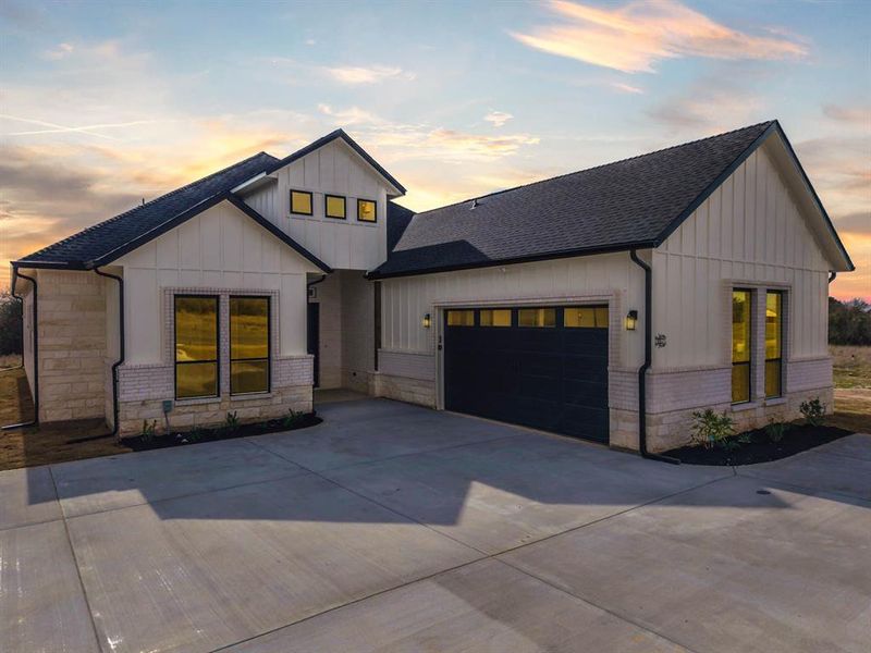 Front exterior of a new home in , Whitney, TX, highlighting curb appeal (Image 20).