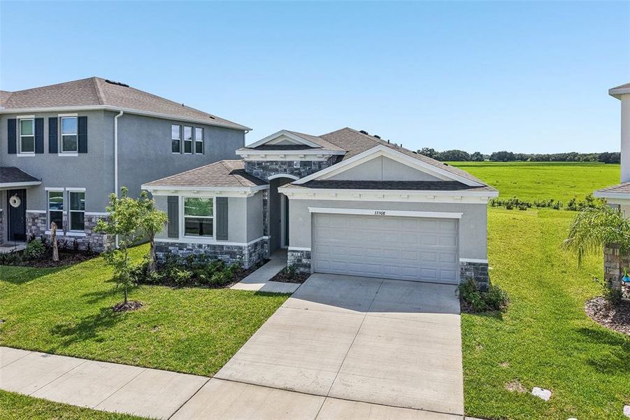 Front exterior of a new home in , Wesley Chapel, FL, highlighting curb appeal (Image 22). Front exterior of a new home in , Wesley Chapel, FL, highlighting curb appeal (Image 22).