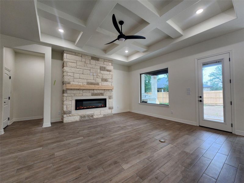 Living area featuring a stone fireplace with a wood mantel and an electric insert