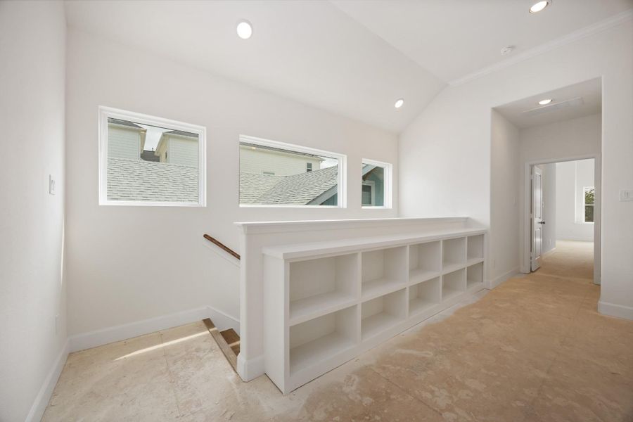 Sunlight streams through clerestory windows, casting the perfect glow on this stylish hallway landing. Bonus: built-in shelving that begs for your favorite reads and travel finds.