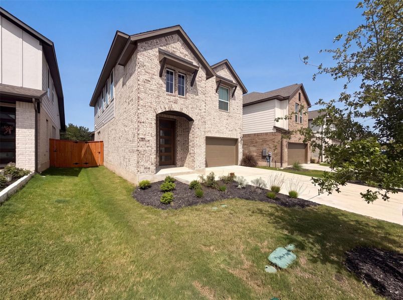 A classic brick exterior, inviting archway, and attached garage create welcoming curb appeal. A classic brick exterior, inviting archway, and attached garage create welcoming curb appeal.