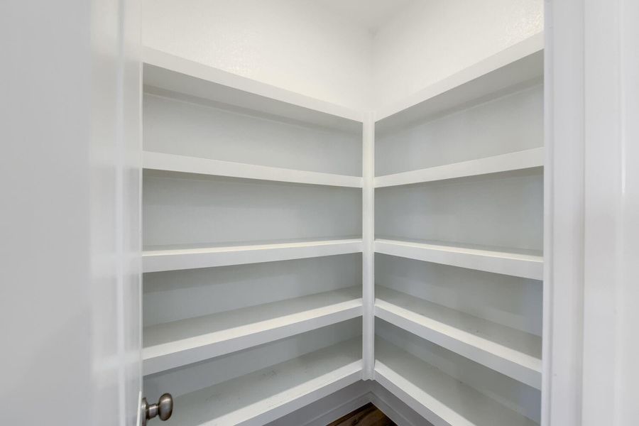 Spacious walk-in pantry with ample shelving for all your storage needs.