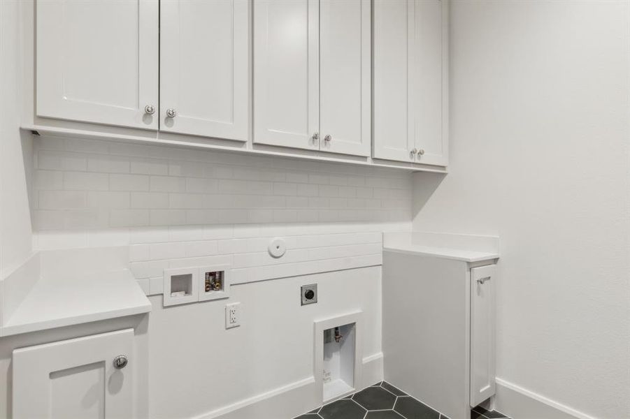 Clothes washing area with hookup for an electric dryer, washer hookup, and cabinets